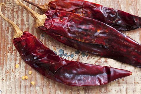El guajillo - 5. Puya chilies. Puya chilies are smaller and spicier than guajillo peppers. They have a light fruity flavor with hints of licorice and cherry, and a heat level between 5,000-8,000 SHU. They are a common ingredient in many dishes like sauces, salsas, dips, enchiladas, stews, soups, casseroles, and cooked vegetables. 6.